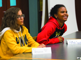 Two Northeast Ohio Students sitting at a desk during meeting.